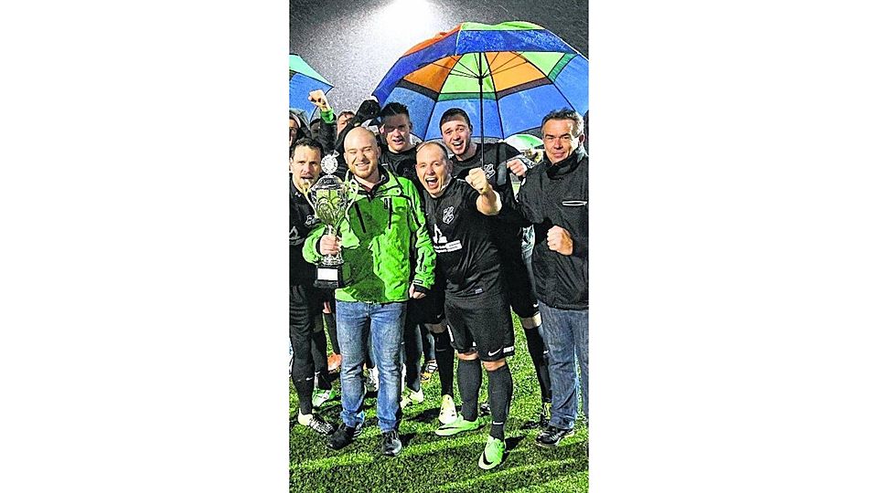 Siegerehrung im Regen: Die Spieler des SV Brachelen jubeln nach dem 5:0-Finalsieg über GW Karken. Foto: Royal