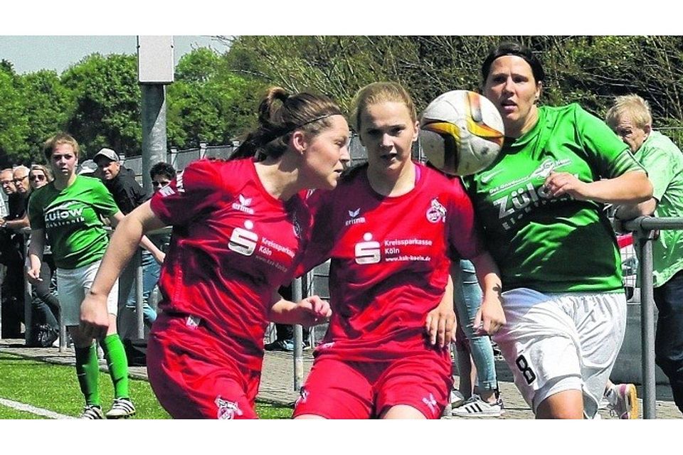 Zwei Spielerinnen des Tabellenführers 1. FC Köln II (links) klären an der Seitenlinie vor Uevekovens Spielführerin Christel Behr. Foto: Royal