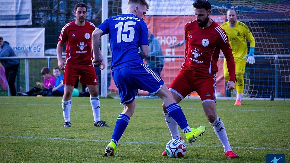 Kampf um jeden Zentimeter: Waldböckelheims Doppeltorschütze Kieran Gätcke (blaues Trikot) und VfL Simmertal-Verteidiger Azad Dag (rechts) im Duell um das Leder.