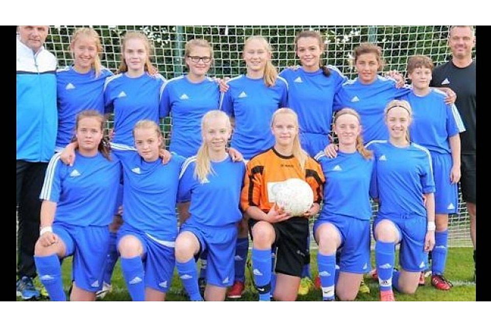 Eingerahmt vom Trainerteam: Die 13 Mädchen der B1-Mannschaft   vom Ahlhorner SV posieren vor ihrem einseitigen 5:0-Sieg gegen den SV Fortuna. ASV