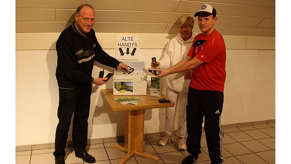 Gisbert Meurs (Geschäftsführer Hauptvorstand), Helgard Reuter (Sportwartin Tennisabteilung) und Initiator Markus Sprenger werfen die ersten Handys in die Sammelbox
