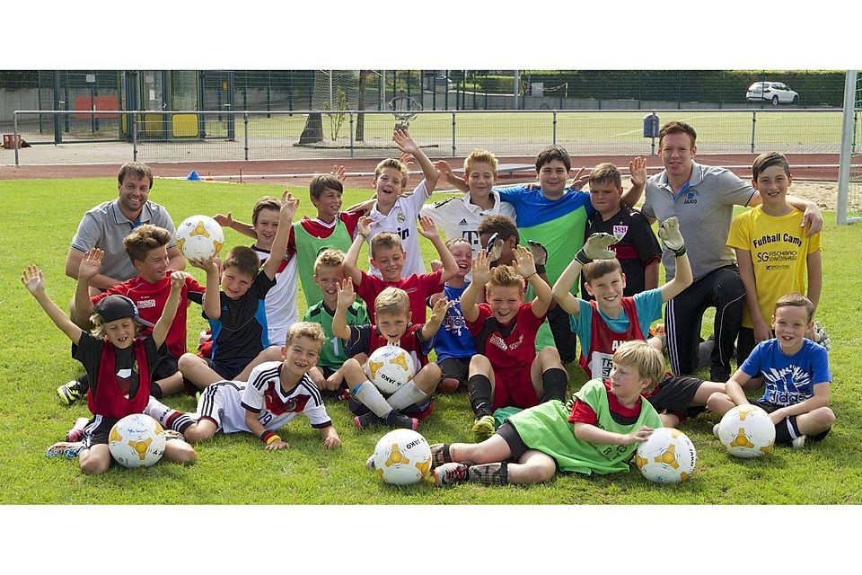 Freuen sich mit den Betreuern über ein schönes Fussball-Feriencamp: die jungen Teilnehmer. GÃ¼nter Kram
