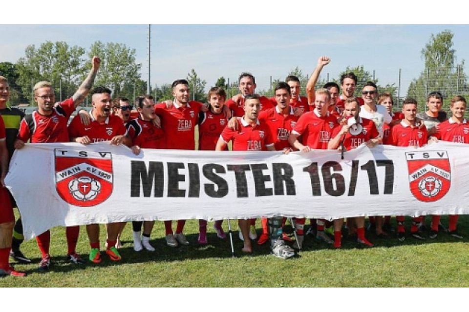 Freudige Gesichter und ein Banner, das alles sagt: Nächste Saison spielt der Meister TSV Wain in der Bezirksliga. Foto: Volker Strohmaier