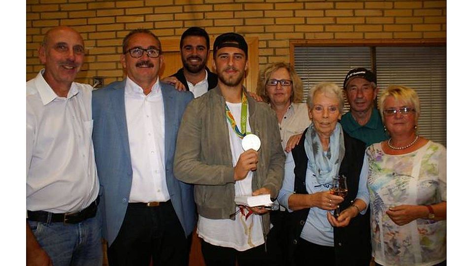 Jannik Huth (Mitte) zeigt stolz seine Silbermedaille im Kreise von Familie und Freunden. Foto: Jens Fink.