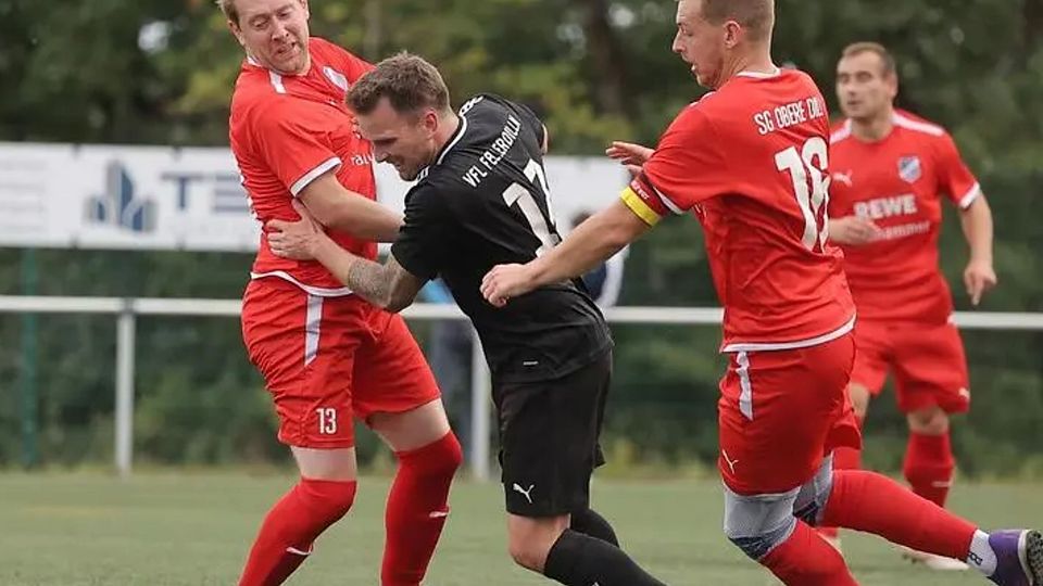 Einen schweren Stand hatte Fellerdillns Christopher Friedrich (M.) im Duell mit Tino Faulhammer (l.) und Jan Niklas Hardt von der SG Obere Dill, die das Derby vor 400 Zuschauern 3:0 gewann und Mitte September die Tabellenspitze übernahm. © Jonathan Ortmann
