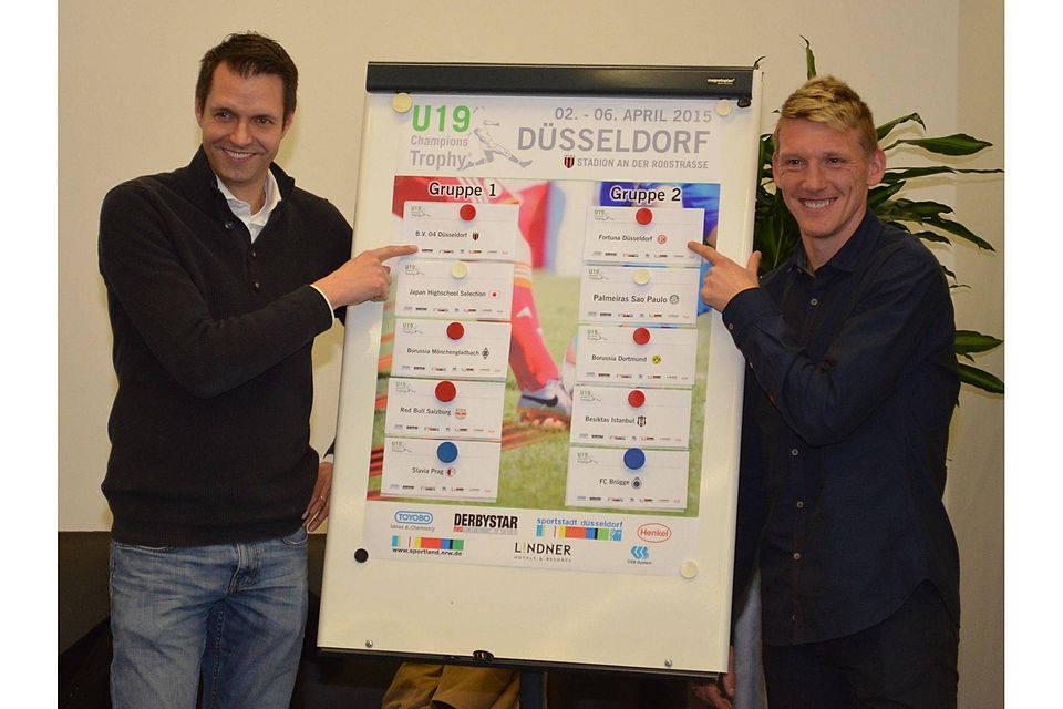 Turnierleiter Martin Meyer und Fortuna-Spieler Axel Bellinghausen zeigen die Gruppeneinteilung. Foto: Piet Keusen