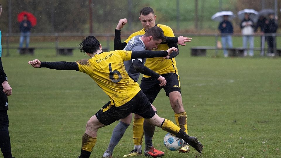Kein Platz für Feingeister: Hohenlindens (grau) Max Attenberger im schlammigen Triell mit den Grafingern (li.) Luis Ladner und Manuel Bauer.