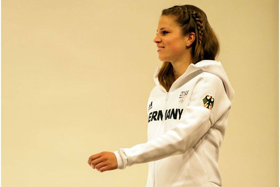 Auf dem Fußballplatz eben Meister geworden, präsentiert Melanie Leupolz hier die Kleidung für die Olympischen Spiele. 	F.: nordphoto