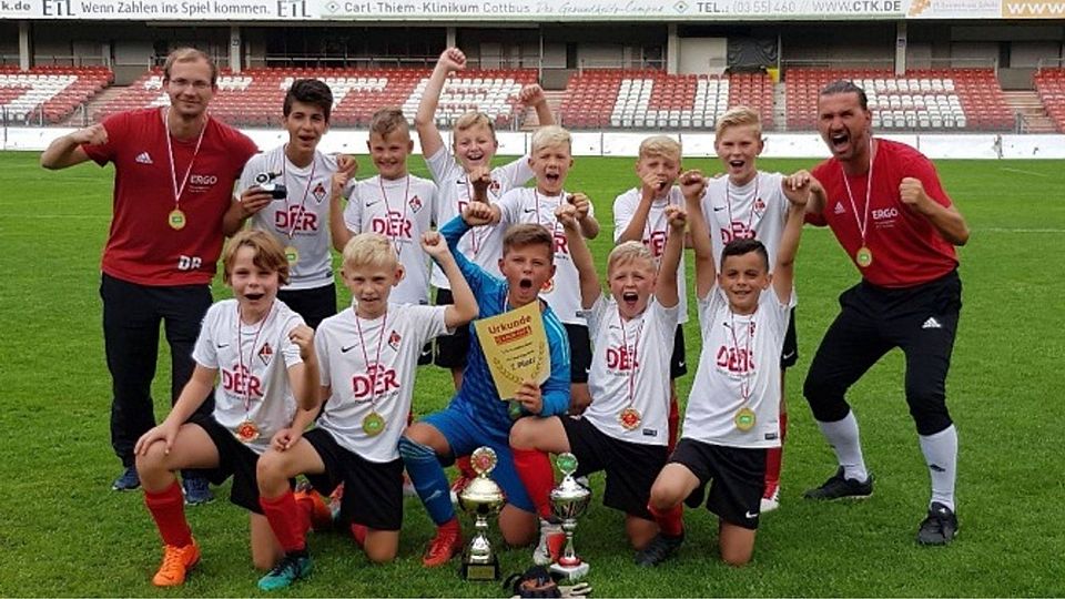 Da haben sie allen Grund zum Jubeln: Die E-Junioren des 1. FC Frankfurt mit ihren Trainern Dominik Rauch (links) und Sascha Geister (rechts) gewannen den Lauzi-Cup, benannt nach dem Maskottchen von Energie Cottbus.  ©Verein