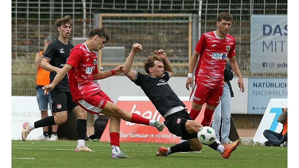 Beim ersten Versuch geblockt, beim zweiten dann nicht mehr aufzuhalten: Wormatias Mittelfeldspieler Laurenz Graf trifft am grätschenden Diefflen-Spieler Nico Theisinger vorbei zum 1:1-Ausgleich. Hinten: VfR-Angreifer Niklas Meyer.	Foto: Christine Dirigo/pakalski-press