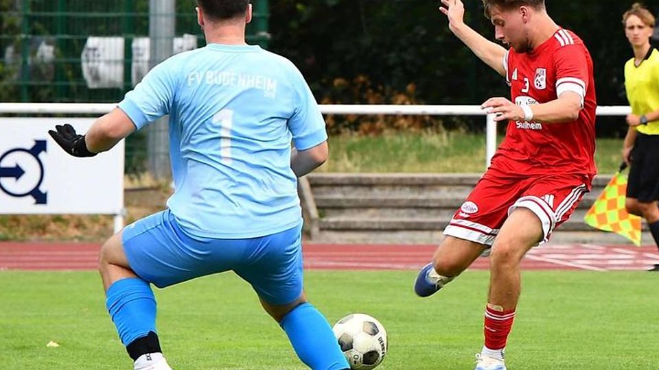 Nieder-Olms Leonard Fabi (rechts) schießt auf das Tor von Budenheim-Keeper Jonas Lehr.