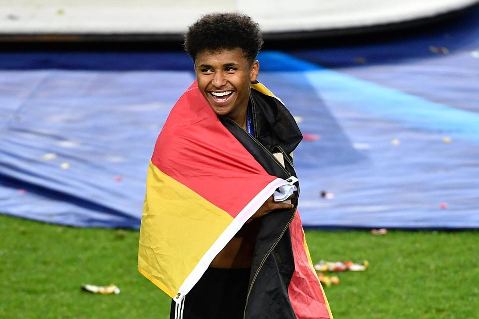Karim Adeyemi nach dem gewonnen EM-Finale in eine Deutschland-Flagge gehüllt.