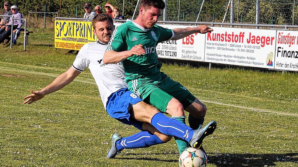 Zielgerichtete Grätsche:  Stockelsdorfs  Julian Wohlfahrt (links) attackiert  Jendrick Nicolay Roepke  vom TSV Dänischburg hart, trifft aber den Ball.tj
