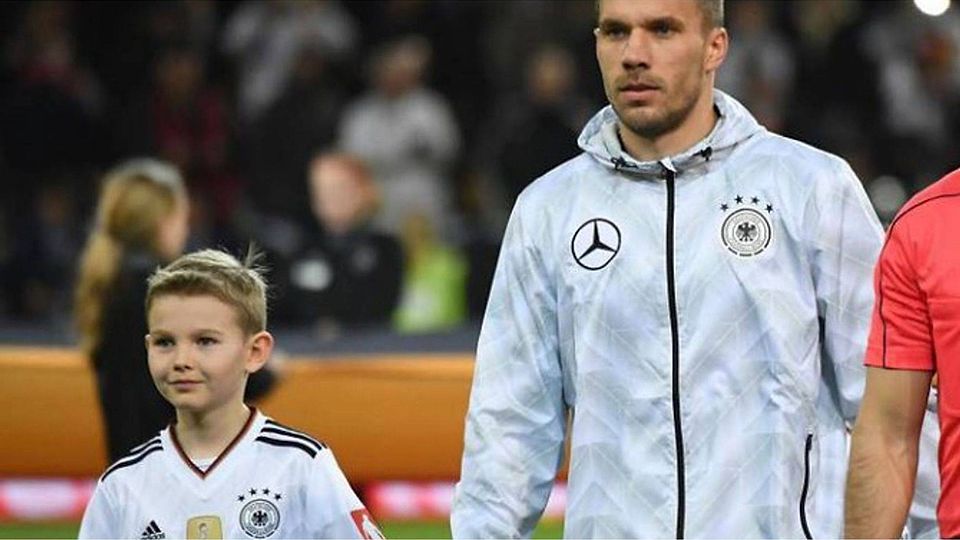 Jakob, Junge aus Bad Kreuznach (l.), an der Hand von Fußballer Lukas Podolski bei dessen Abschiedsspiel aus der Nationalmannschaft. Foto: Jan Hübner